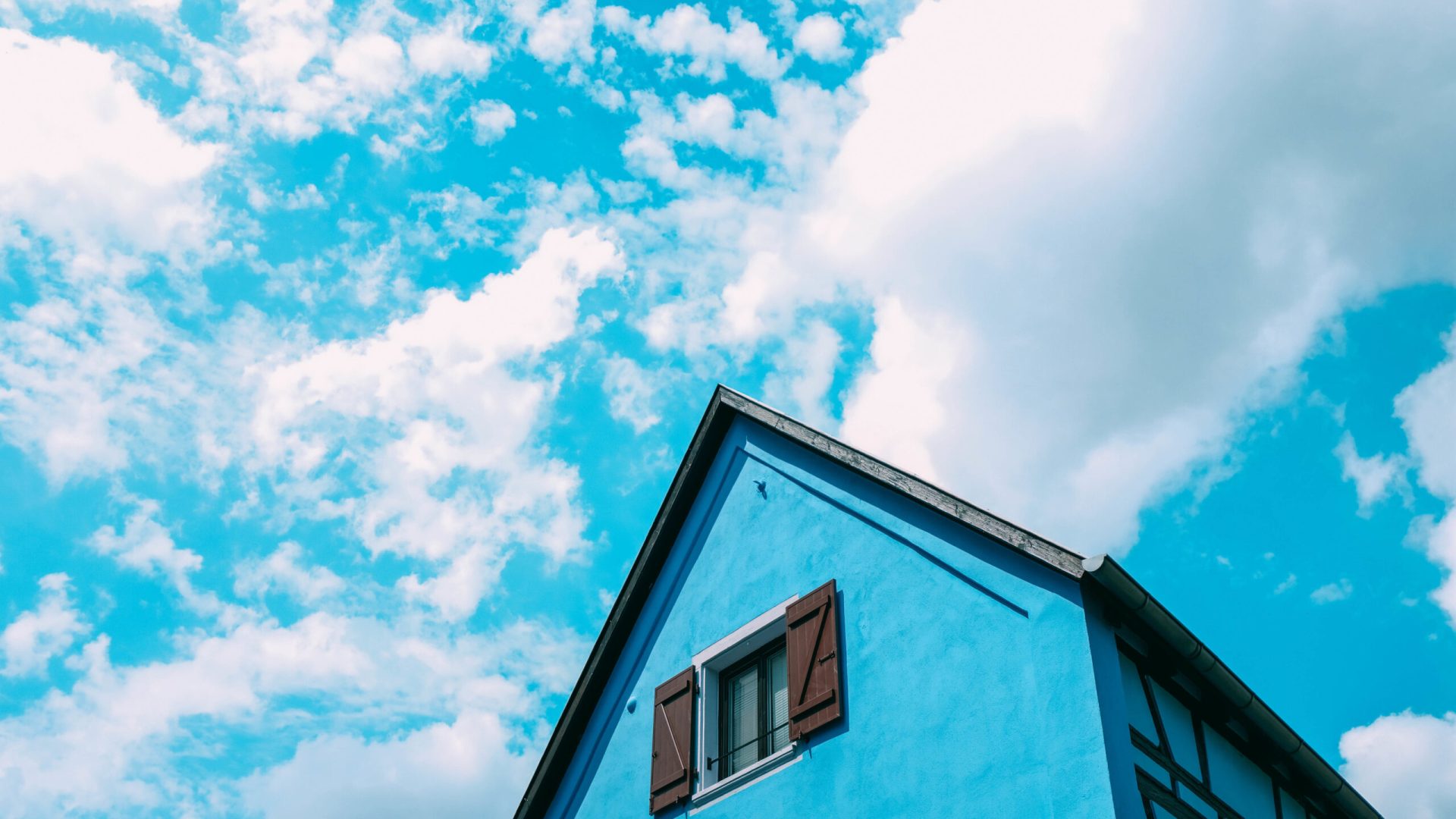 the-wooden-gables-of-blue-house-under-a-blue-sky